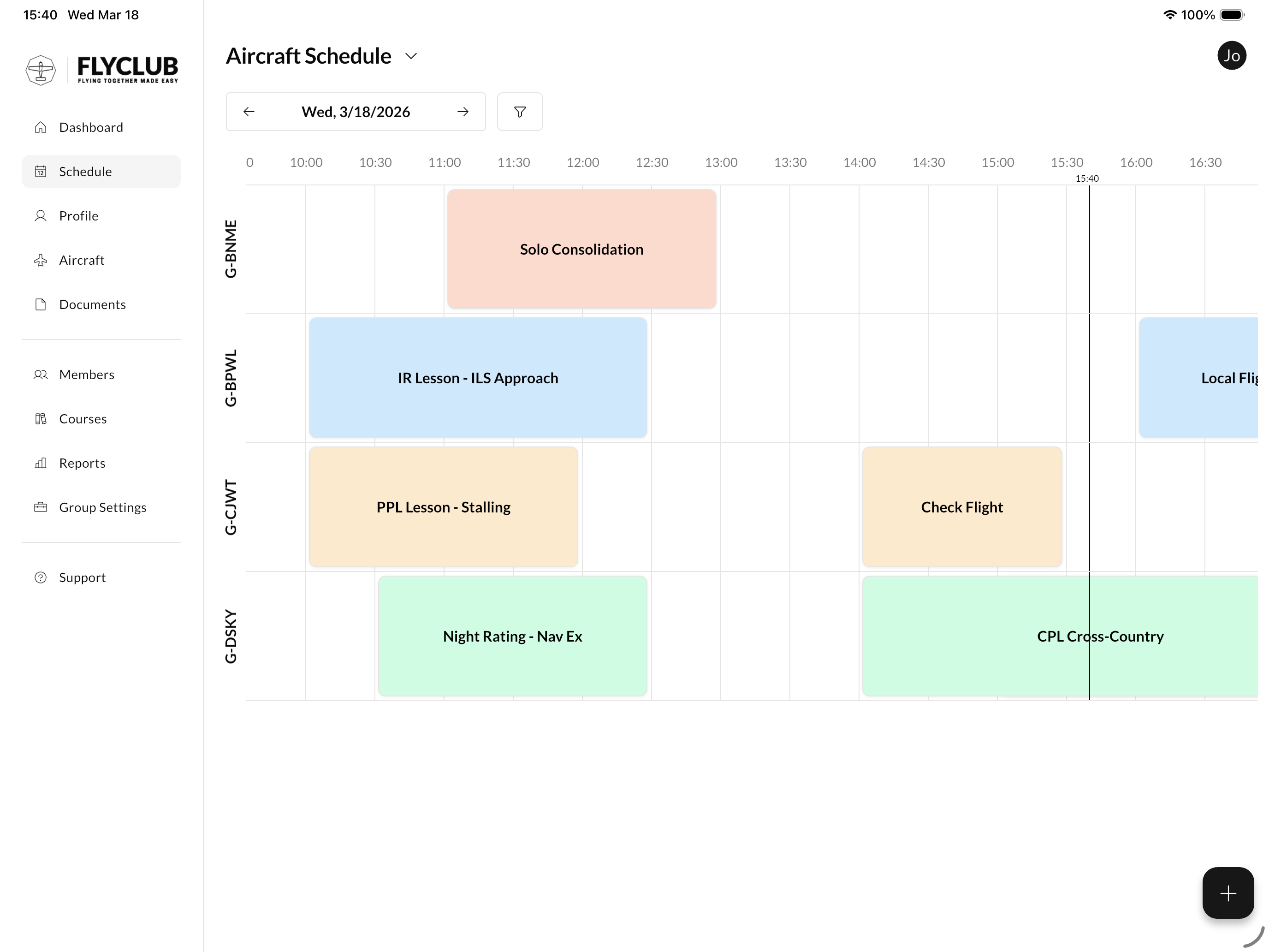 Flight schedule calendar on iPad showing color-coded bookings across multiple aircraft